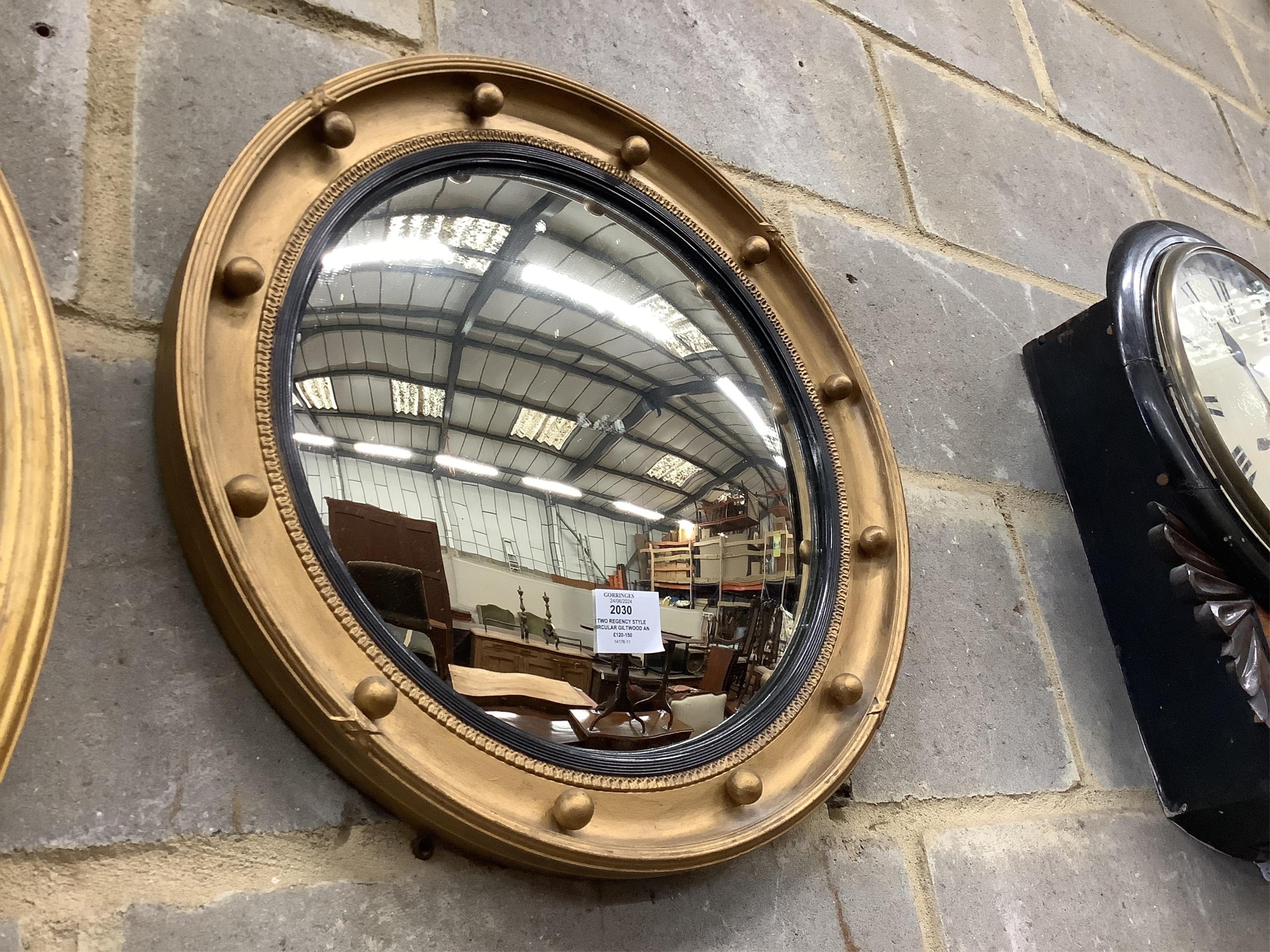 Two Regency style circular giltwood and composition convex wall mirrors, larger diameter 58cm. Condition - fair